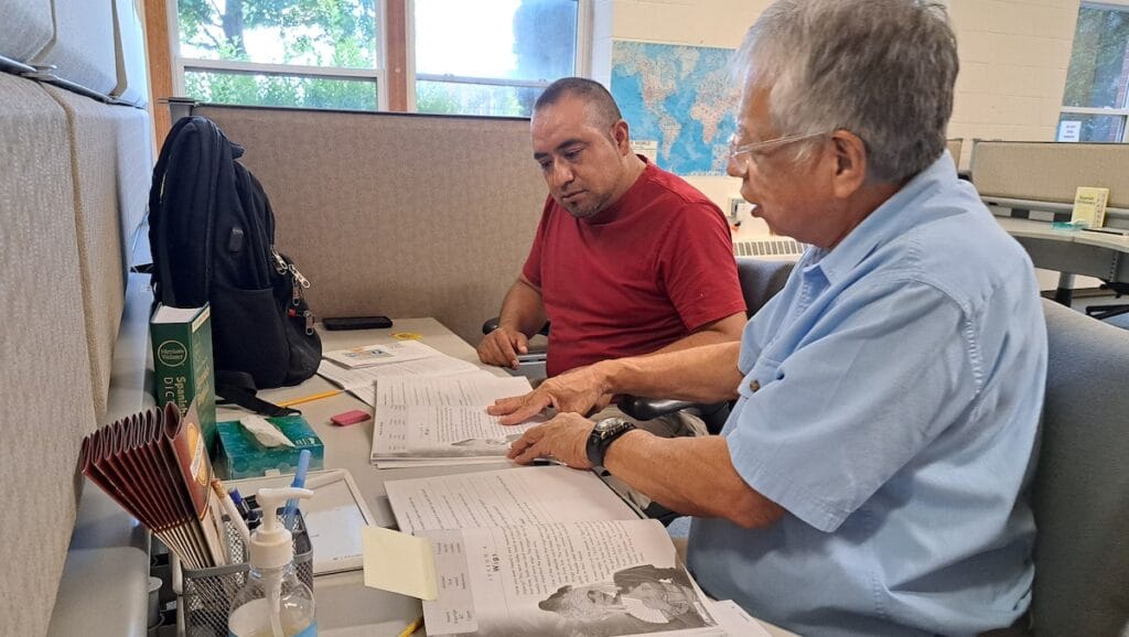 Andres Briones works with tutor Joel Rodriguez at the Adrian Rea Literacy Center. Briones, who lives in northwest Ohio, has found increased opportunities at work as a result of the learning he’s done at the center. (Photo by Arlene Bachanov)