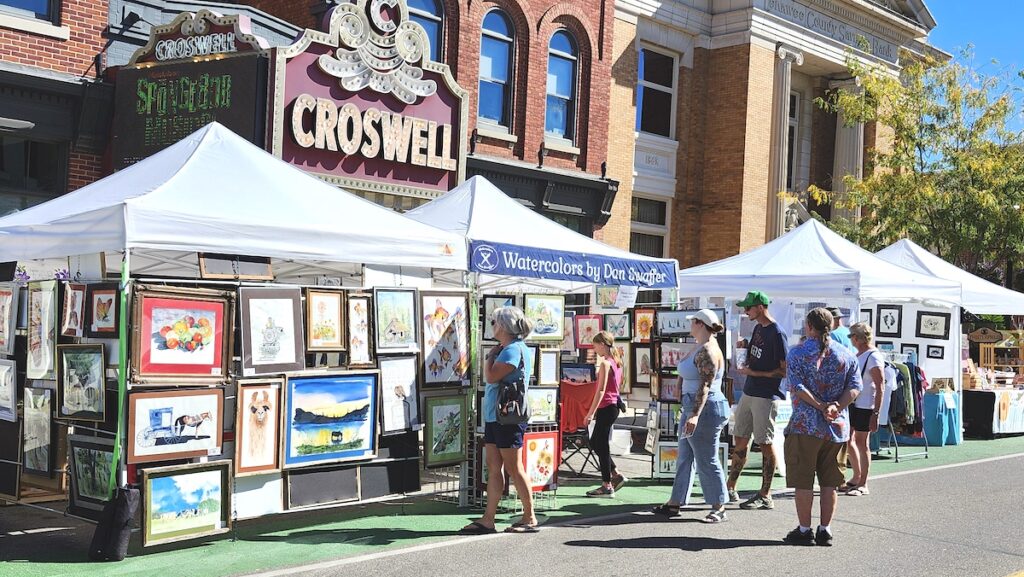 People browse artists’ tents at the 2024 Artalicious festival in downtown Adrian. (Photo by Erik Gable)