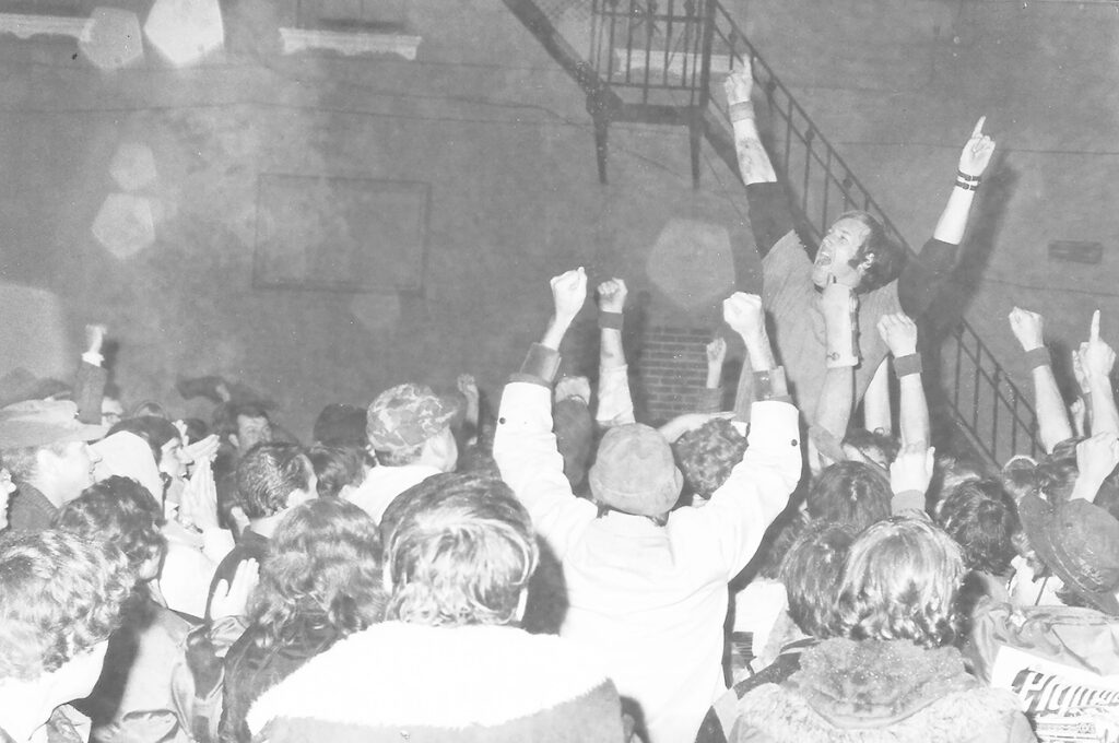 Coach Tom Saylor is hoisted in the air during a victory celebration in downtown Hudson on Nov. 11, 1972, after Hudson beat Morenci 42-0 to tie the previous state winning streak record of 44 games. (Photo courtesy of Mike Mills, Hudson Museum)