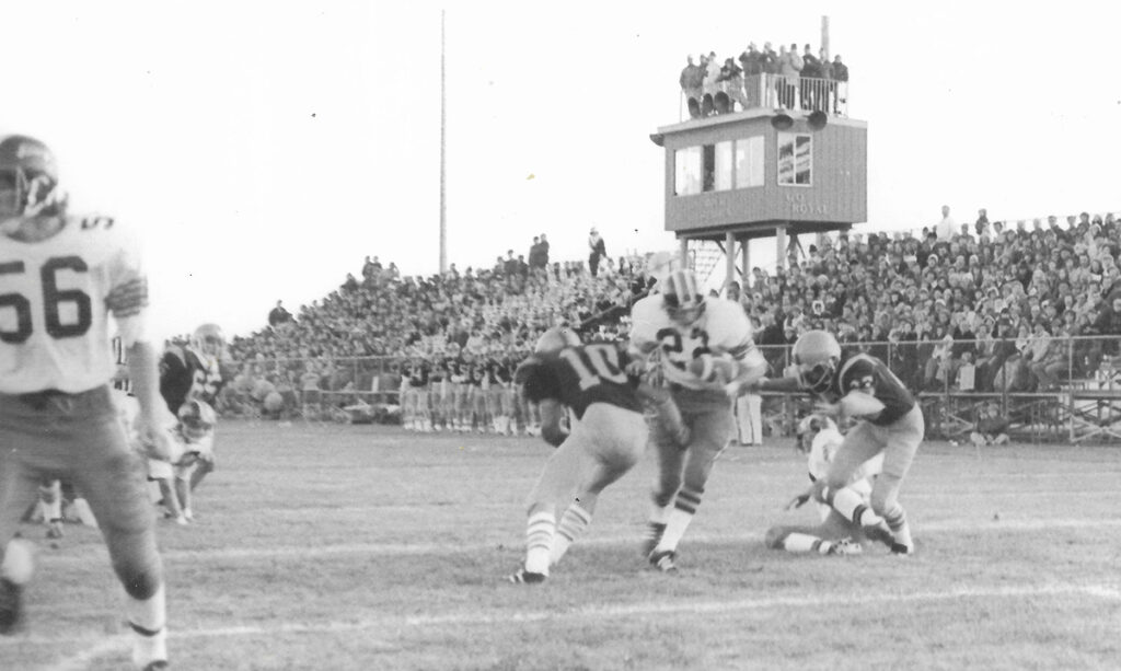Halfback Greg Gutierrez scores in Hudson’s 1975 season opener, in which the Tigers defeated Blissfield 32-0 for their 63rd win in a row during the team’s record-setting 72-game winning streak. (Photo courtesy of Mike Mills, Hudson Museum)