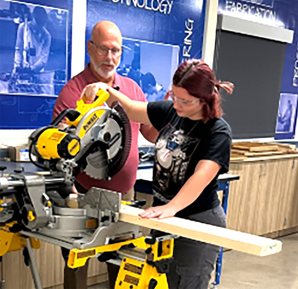 Adrian High School student Liliana Earles works with teacher Tony Aiken in the AHS Industrial Arts program.