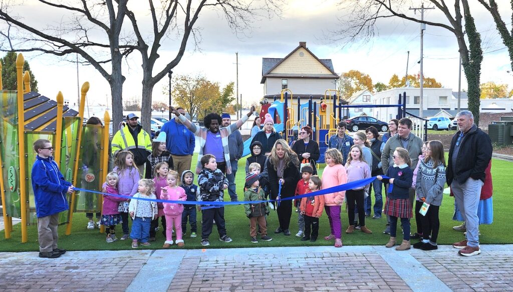 Mayor Angela Sword Heath, center, dedicates the new playground in Library Square in downtown Adrian on Nov. 5.