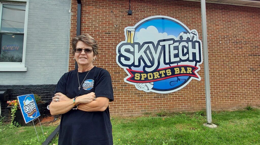 Sheila Ruttkofsky is pictured outside Skytech Sports Bar, located at the former VFW Hall on North Main Street in Adrian. (Photo by Julie C. Clemes)