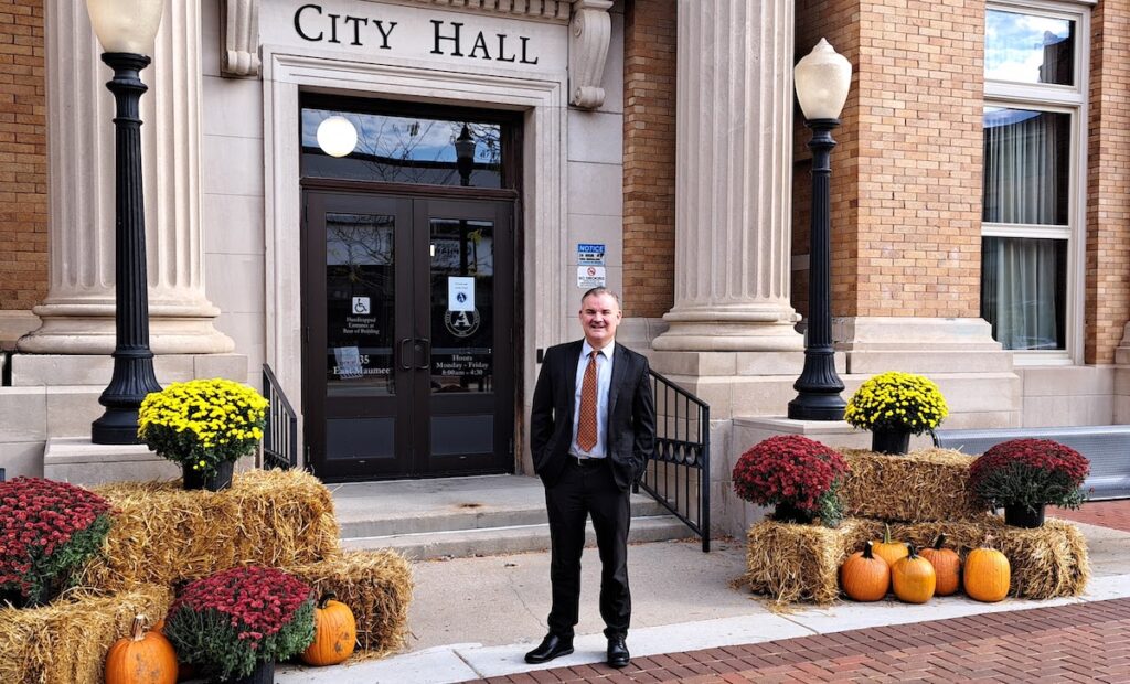 Chad Baugh, pictured in front of Adrian City Hall, started work as Adrian’s city administrator on Sept. 22. (Photo by Arlene Bachanov)