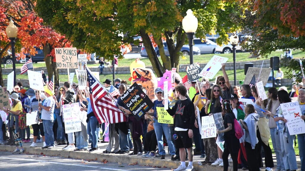 People line West Maumee Street in Adrian during a protest against the Trump administration on Oct. 18.