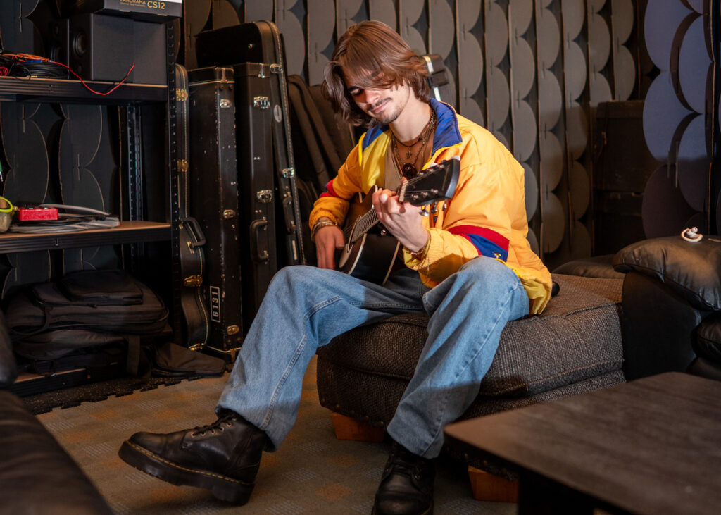 Trent Aneed, 17, works on his guitar skills in the Above Pete’s Garage studio space at 5353 West U.S. 223. (Photo by Lad Strayer)
