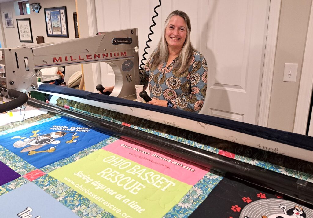 Kendra Warner is pictured at her Lenawee County home with her longarm quilting machine, loaded with a T-shirt quilt she was creating for her sister. (Photos by Arlene Bachanov)