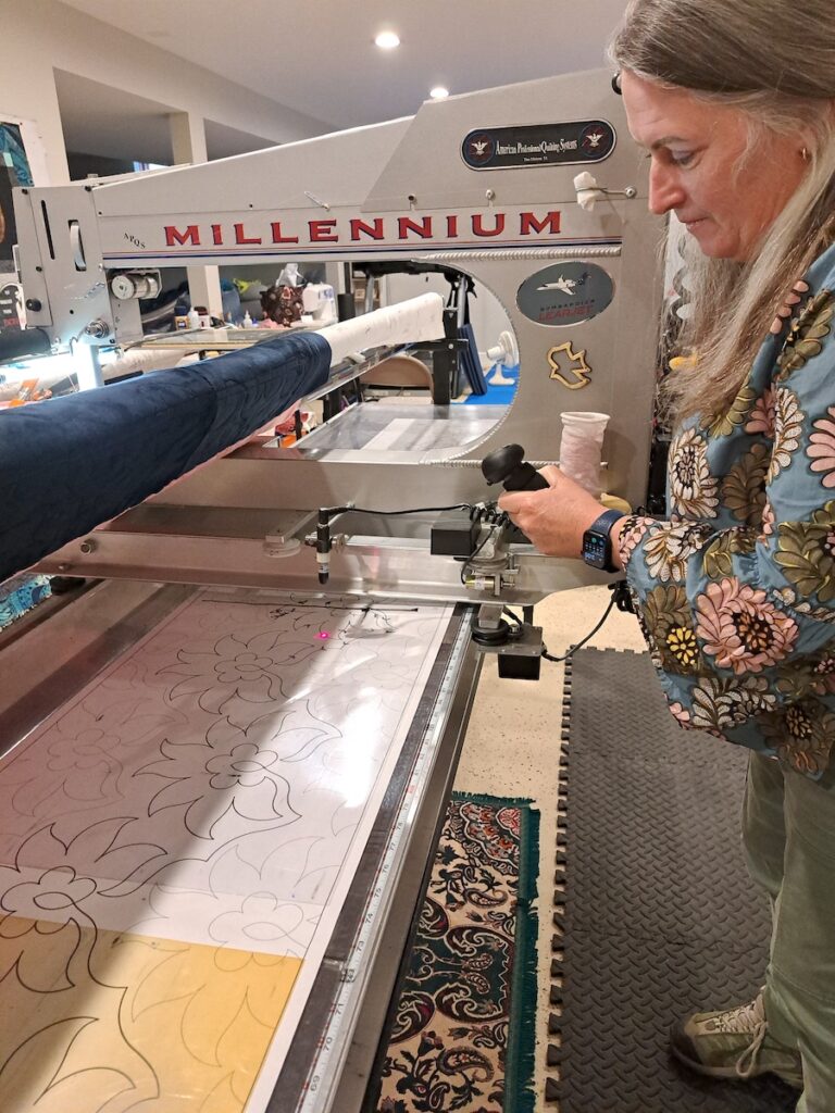 Kendra Warner works on a quilt in her basement workshop. Warner, an Air Force veteran, first got interested in quilting while she was stationed in Guam and now owns Veteran Threads Quilt Co. (Photo by Arlene Bachanov)