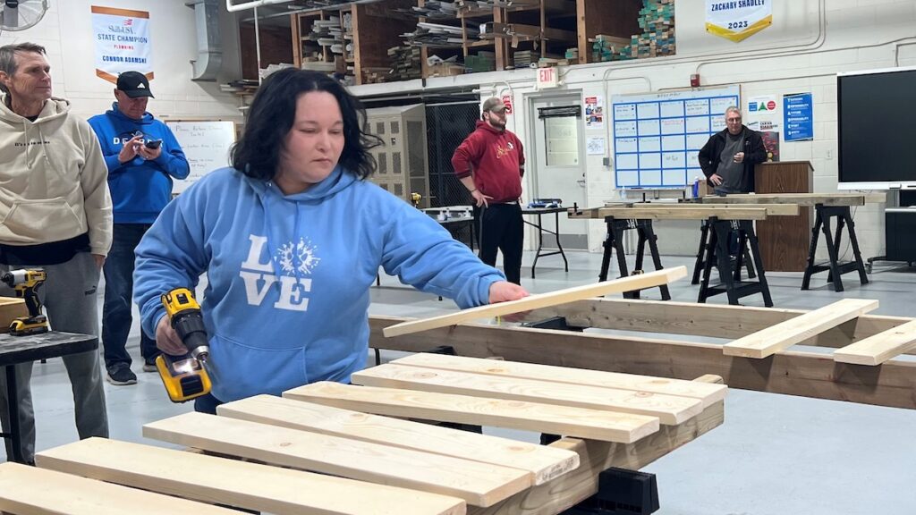Christina Villalobos, foreground, takes part in a Nov. 8 event at the Lenawee Intermediate School District Tech Center to build beds for Sleep in Heavenly Peace. The Tech Center hosted the build and St. John’s Lutheran Church sponsored it. Fifty beds were built at the event, and they were delivered by volunteers to kids around Lenawee County the following Saturday. )Photo courtesy of the LISD)