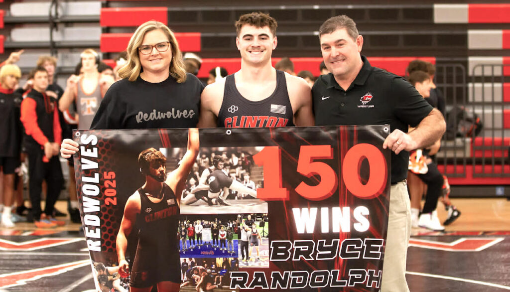 Clinton wrestler Bryce Randolph, with his parents Laurie and Casey, celebrates his 150th win on Dec. 3.