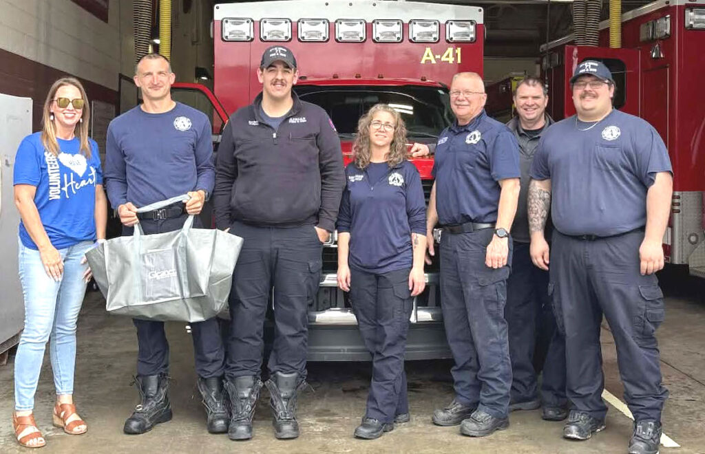 Gleaner Legacy Arbor’s Kristin Horton, left, is pictured delivering a bag of comfort kits at the Adrian Fire Department.