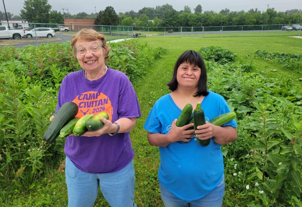 Pictured harvesting vegetables from the HOPE Center’s garden are Gail Sayler and Mona Moreno. (Photo courtesy of HOPE Community Center)
