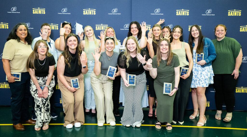 Former Siena Heights softball players who were inducted into the AHU Athletics Hall of Fame display their 2019 WHAC tournament championship rings during Alumni Weekend.
