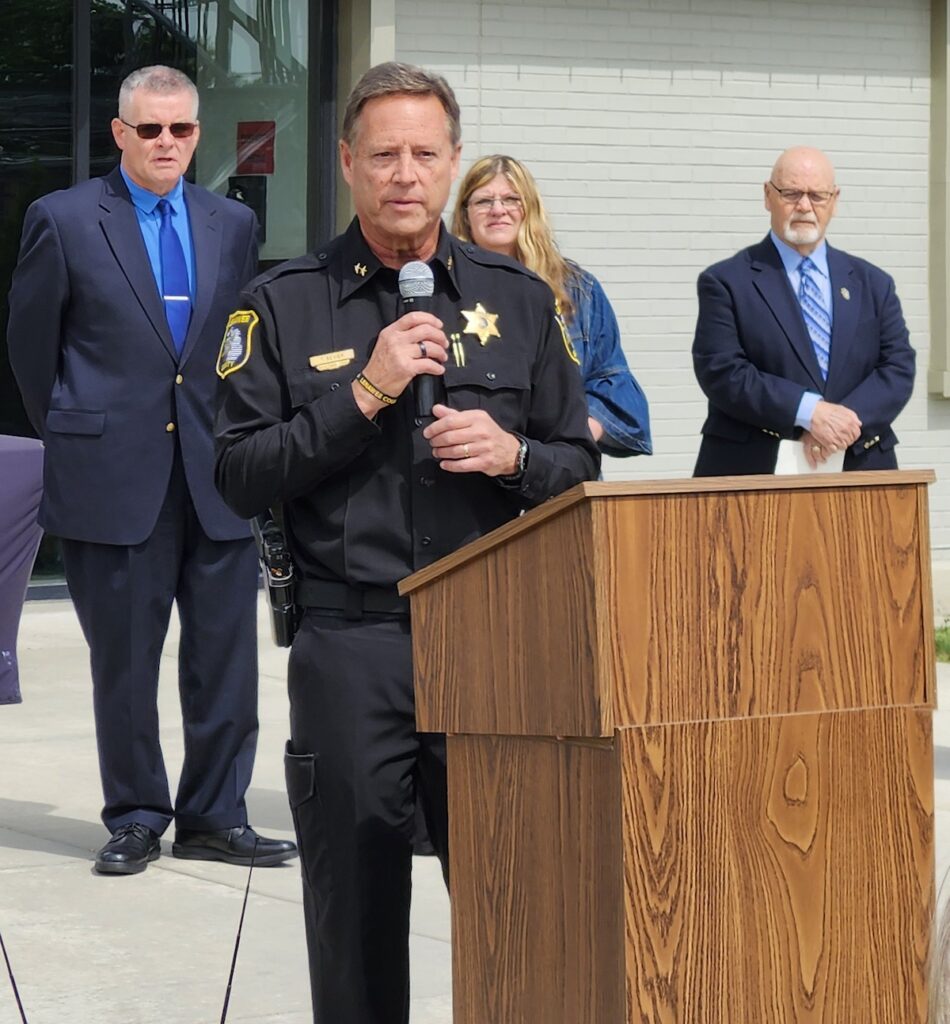 Sheriff Troy Bevier speaks at the dedication of the Lenawee County Sheriff’s Office building in honor of Richard Germond.