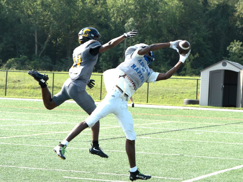 Adrian’s Jordan Griffin catches a pass during a preseason scrimmage against Lansing Waverly on Aug. 21. (Photo by Lad Strayer)