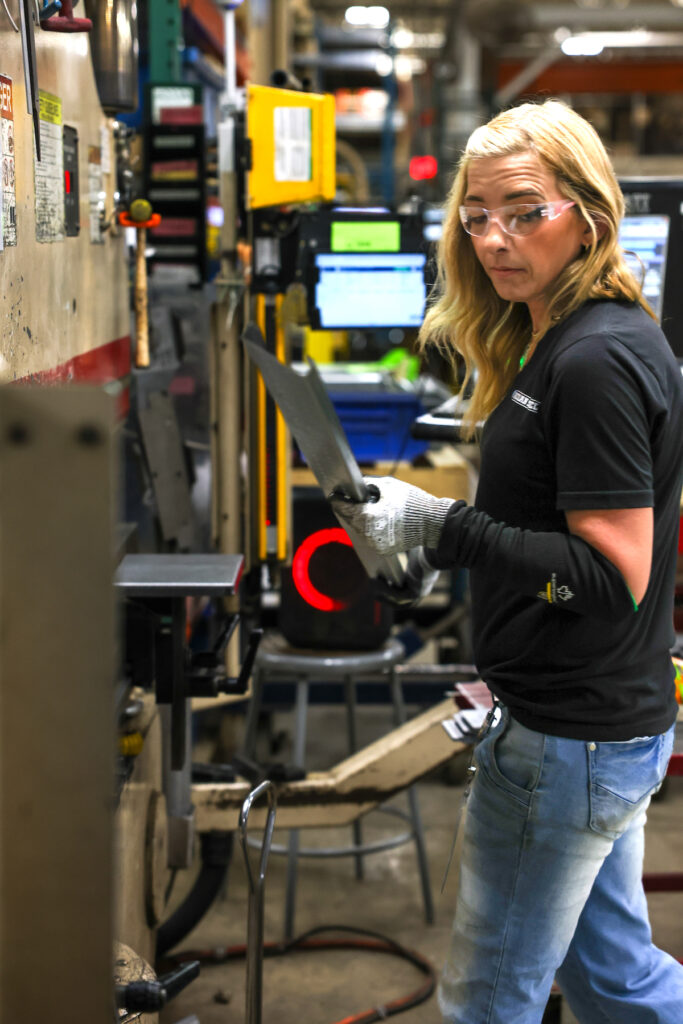 Loren Hall operates a break press, forming precision components as part of the manufacturing process at Adrian Steel. (Photo courtesy of Adrian Steel)