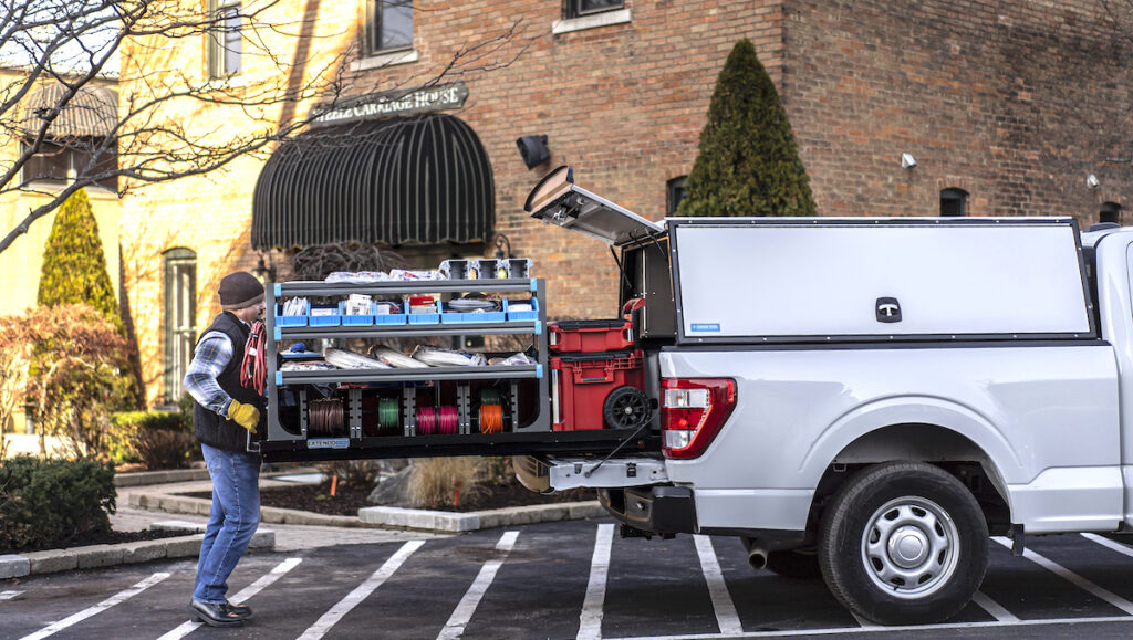 Adrian Steel makes automotive aftermarket equipment and commercial cargo management solutions for the skilled trades. This image, taken in downtown Adrian, shows an integrated pickup truck solution with a modular truck cap, Extendobed slide-out, integrated shelving and a ladder rack. (Photo courtesy of Adrian Steel)