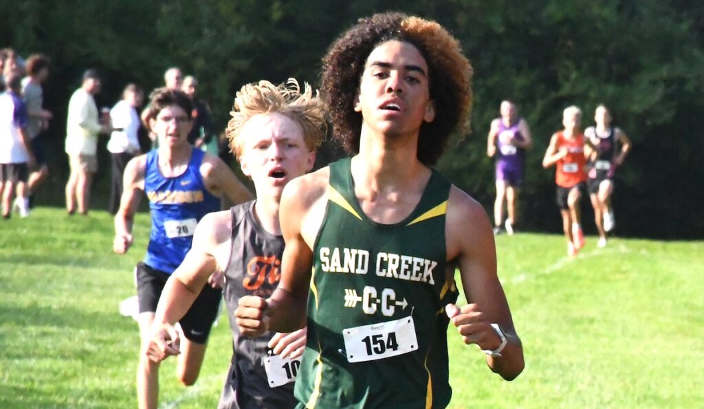 Tre Fluker from Sand Creek, Haven Kohlruss from Hudson, and John Verlinde from Madison come up on the finish line at the Lenawee County cross country preview meet. (Photo by Erik Gable)