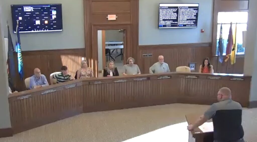City commissioner Bob Behnke, right, answers questions from other commissioners during the Aug. 3 meeting.