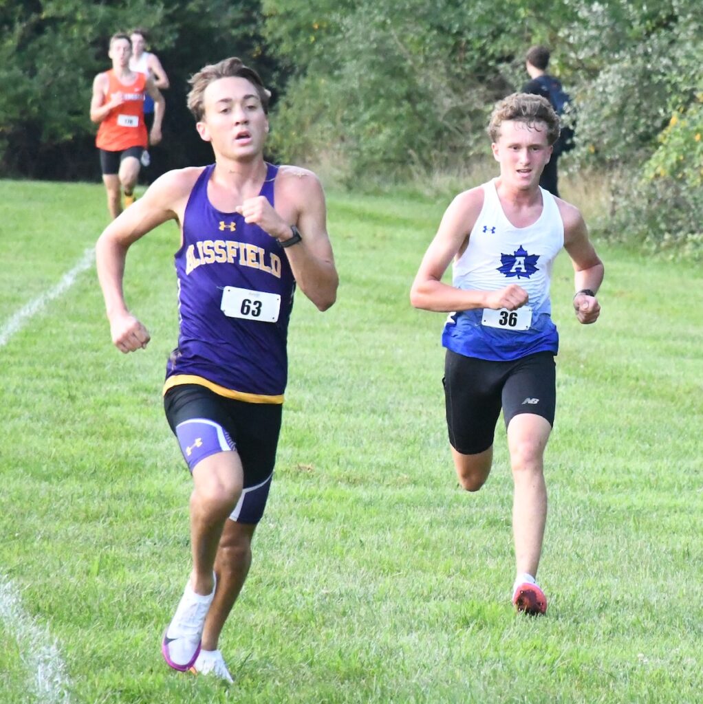 Blissfield's Michael Weidmayer pulls ahead of Adrian's Parker Smith at the end of a close race at the Lenawee County preview meet on Aug. 22. Weidmayer had the fastest time by a half-second.