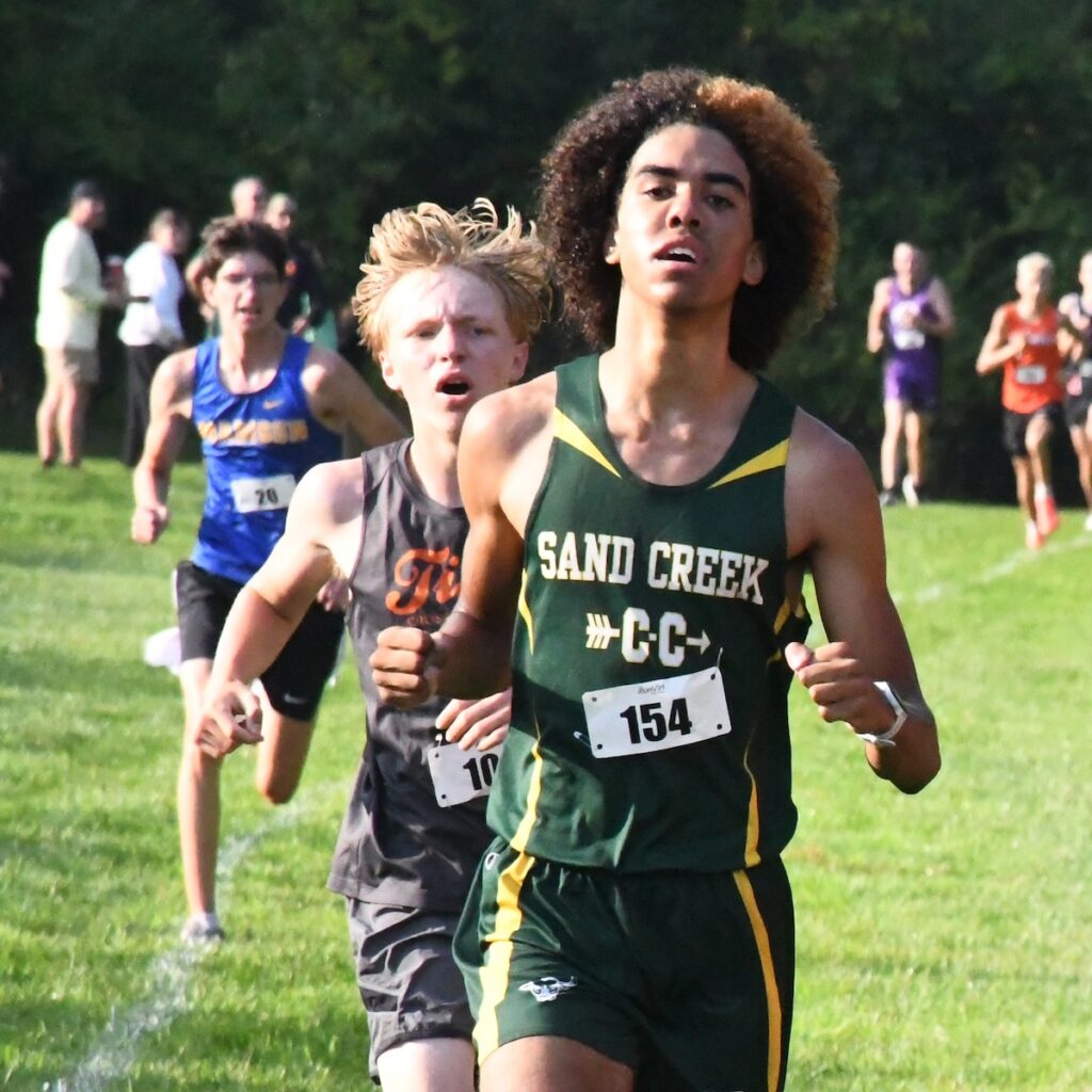Tre Fluker from Sand Creek, Haven Kohlruss from Hudson, and John Verlinde from Madison near the finish line at the Lenawee County cross country preview meet.