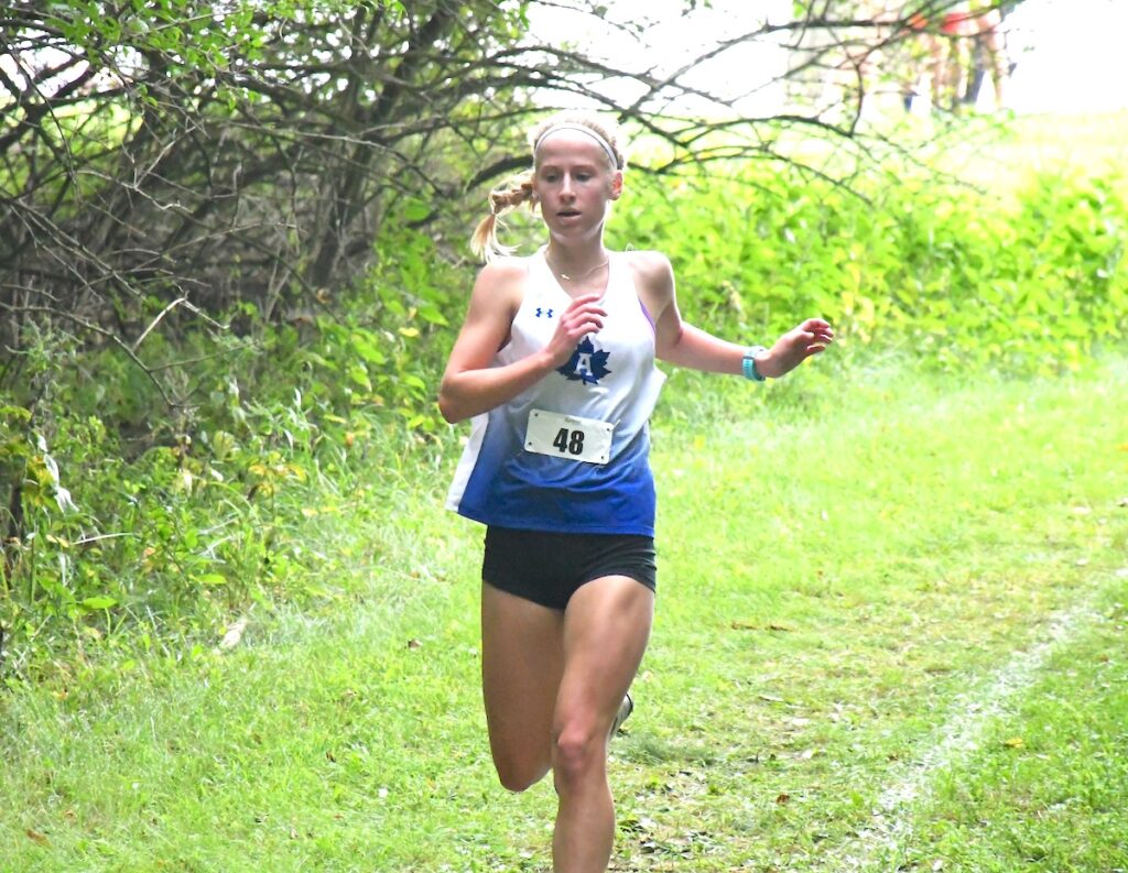 Ayda Skeels comes around the bend partway through the course at the all-county cross country preview meet.