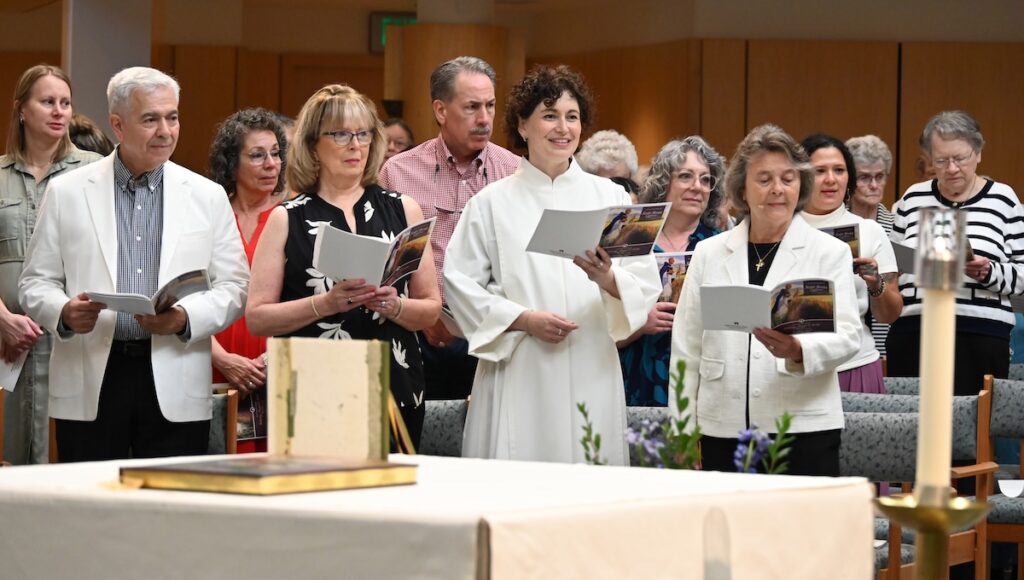 Sister Jamie Caporizo, OP, is pictured during her First Profession of Vows with her parents, James and Sheila Caporizo, and Sister Elise D. García, prioress of the congregation.