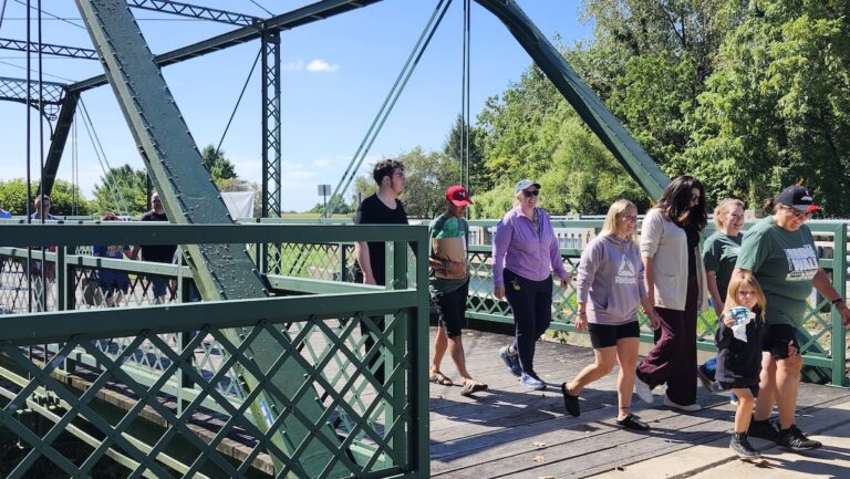 People finish crossing the Silver Creek Bridge at the 2025 bridge walk. This year’s bridge walk will take place at 11 a.m. Monday, Sept. 7. (Photo by Erik Gable)