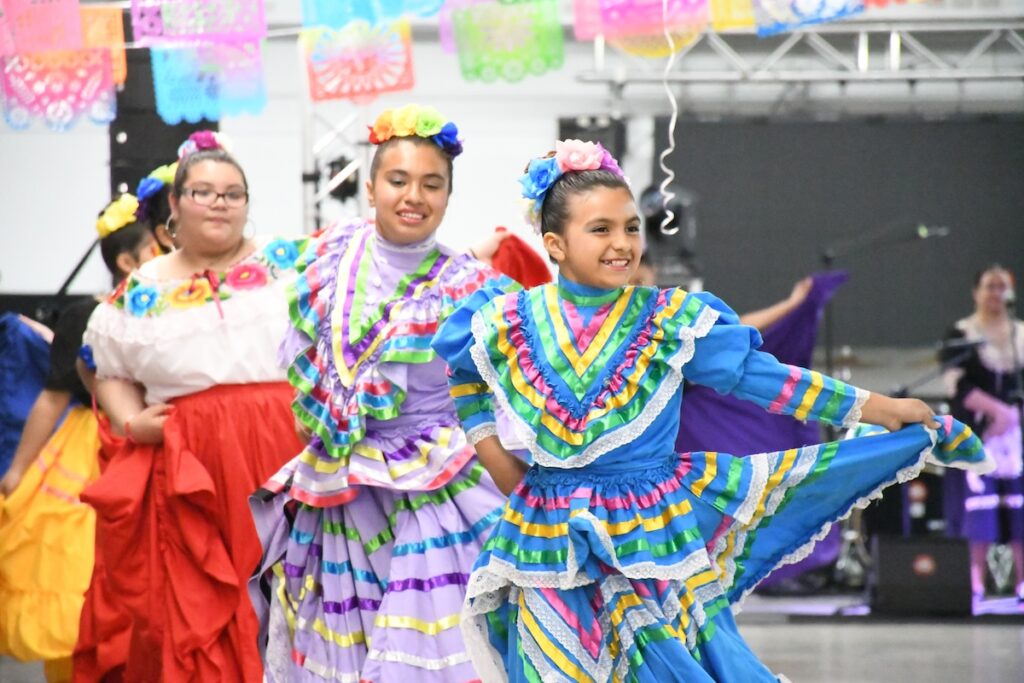 Analise Carabajal-Ortiz, Selena Solis, and Daisy Solis perform with the Raíces de mi Tierra dance troupe at this year’s Cinco de Mayo celebration at the Lenawee County Fair & Event Grounds. (Photos by Erik Gable)