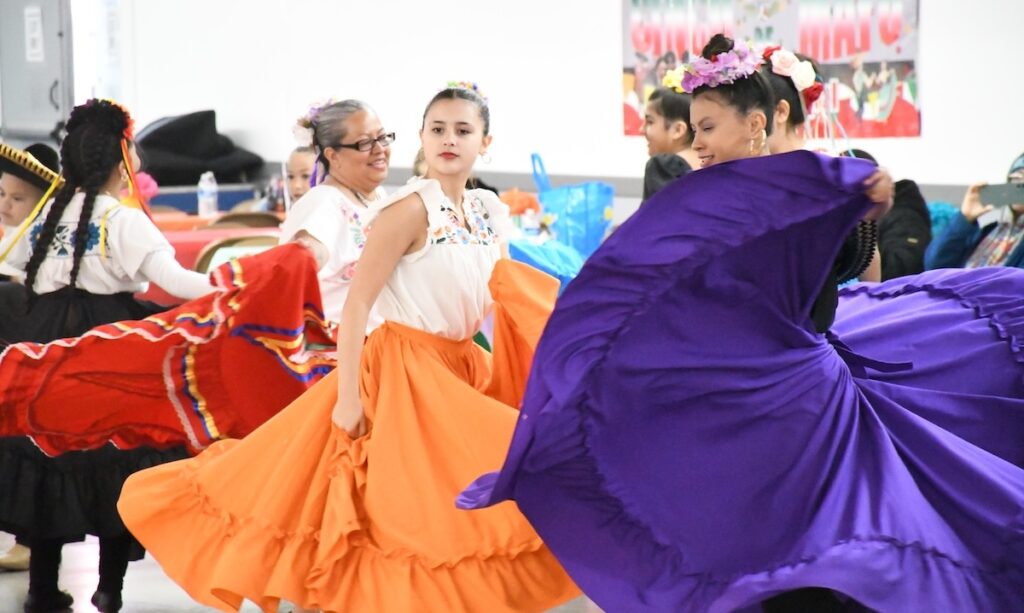 Longtime instructor Raquel Ybarra dances alongside students Gianna Clark and Lylah Gutierrez at this year's Cinco de Mayo.
