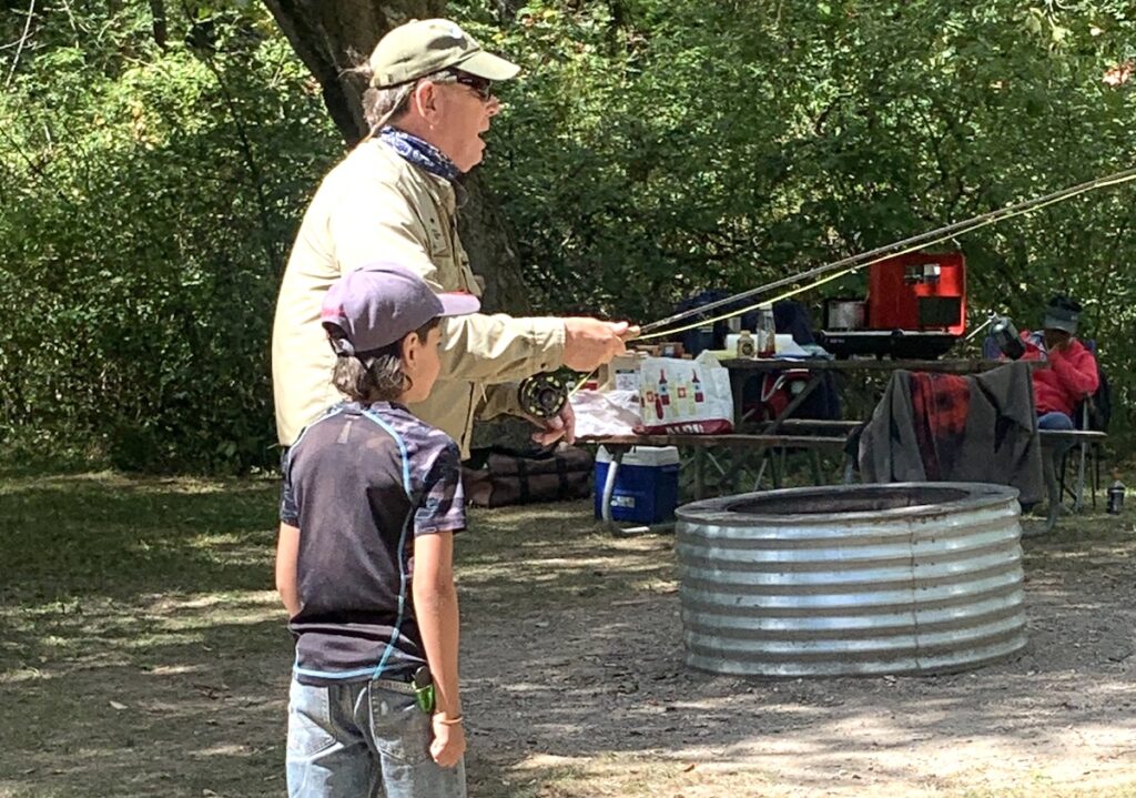 A volunteer from Trout Unlimited teaches kids about fishing at a previous Great Outdoors Youth Jamboree.