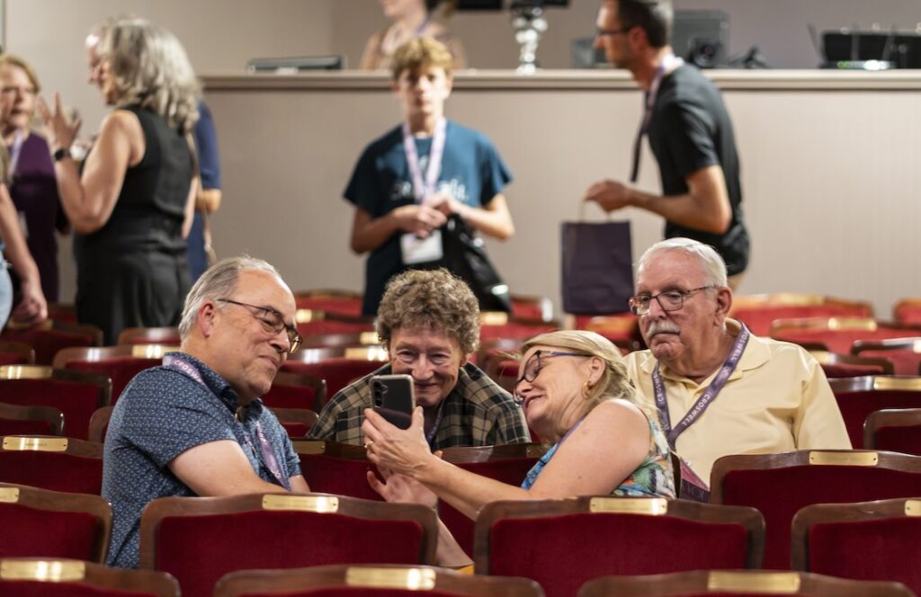 Nathan Smith, Alyce Mott, Kathryn Smith and Ken Hamlin look at a photo during the Croswell Family Reunion on Aug. 7. (Photo by Ashlee Sayles)