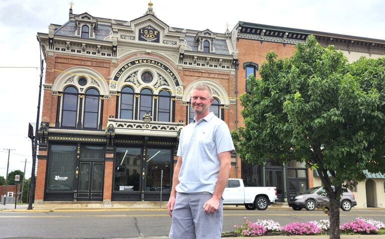 Brad Maggard stands in front of Clark Memorial Hall, the 1888 Odd Fellows hall on Winter Street. The building’s restoration was recently singled out for recognition by the Michigan Historic Preservation Network. (Photos by Erik Gable)